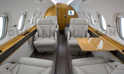 Hawker 800 interior in warm gray and honey-toned wood
