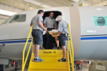 Falcon 7X technicians discussing maintenance tasks