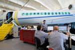 Falcon 7X technicians discussing maintenance tasks