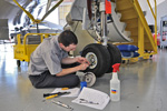Falcon Tech performing maintenance on nose wheel