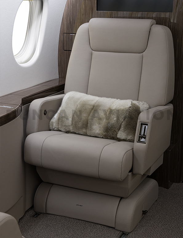 Refurbished seat with cool beige leather on Falcon 900 by Duncan Aviation