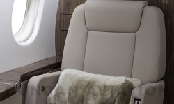 Refurbished seat with cool beige leather on Falcon 900 by Duncan Aviation
