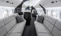 Modern gray facing divans of interior refurbishment in Falcon 2000