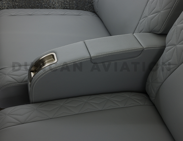 Close up of arm rest upholstered in gray leather in Falcon 900