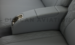 Close up of arm rest upholstered in gray leather in Falcon 900