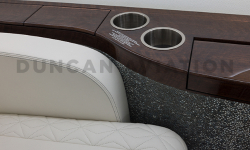 Close up of drink rail with built in cup holders next to white leather upholstered seat in Falcon 900