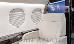 Cream leather captain chair in refurbished Falcon 7X by Duncan Aviation