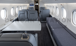 Interior of Falcon 2000 interior refurbishment with soft gray upholstery and conference table
