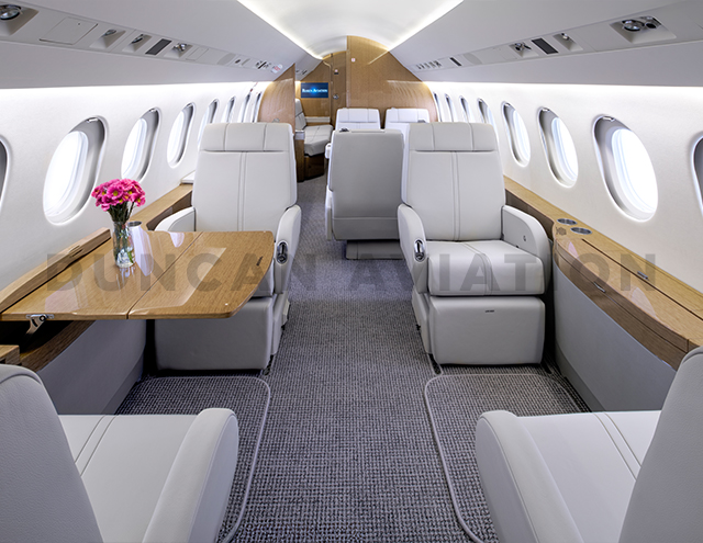 Light gray interior with light wood tones of Falcon 900