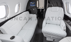 White leather club seat and divan with custom diamond stitching in Hawker 800