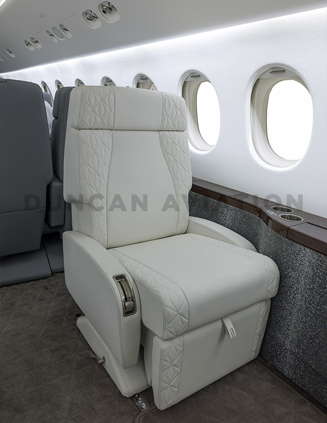 Full club seat upholstered in white leather with star stitching on edges in Falcon 900