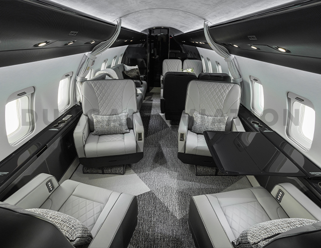Four leather club seats in gray interior of Challenger 604