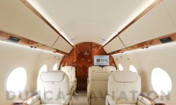 Refurbished interior of Gulfstream 650 with cream leather and warm wood