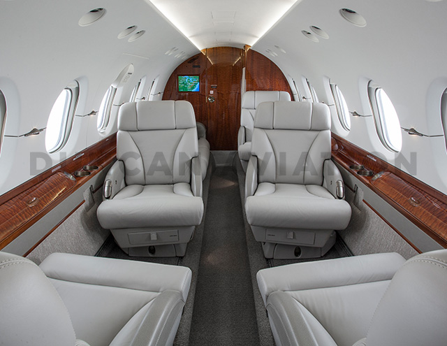 Updated interior of Hawker 800 in cool gray and warm wood tones