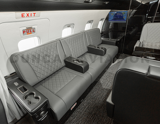 Gray leather upholstered couch seats in Challenger 604