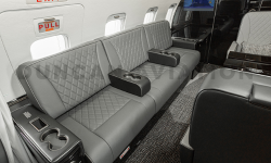 Gray leather upholstered couch seats in Challenger 604