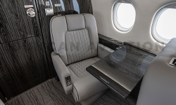 Alternate angle of club seat and conference table in refurbished Falcon 2000
