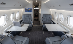 Blue-gray club seats with white conference tables-Falcon 2000 interior refurbishment