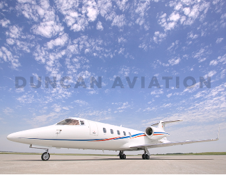 Sleek Learjet 60 exterior with new white paint and blue and red accent stripes