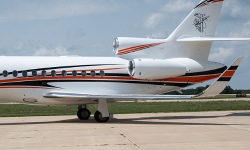 Tail and engines of Falcon 900 painted by Duncan Aviation with orange and navy stripes on white