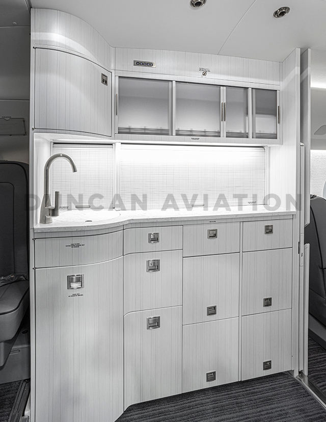 Sleek all white galley interior refurbishment in Falcon 2000