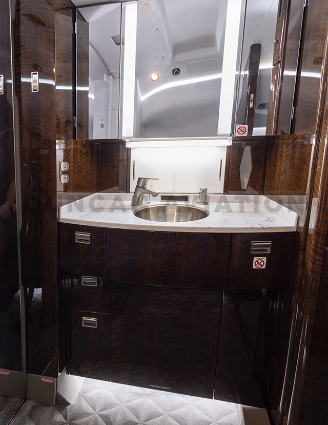 Lavatory of Falcon 900 with dark wood finishes
