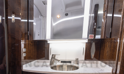 Lavatory of Falcon 900 with dark wood finishes