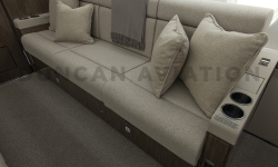 Divan to seat three in cool beige leather with matching pillows on refurbished Falcon 900