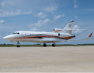 Exterior of Falcon 900 in white with blue and orange strip painted by Duncan Aviation