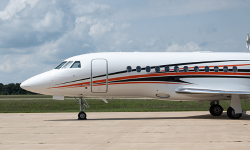 Falcon 900 painted in white with dynamic orange and navy stripe