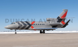 Exterior of Falcon 900 with gray paint and dark gray and red accents