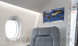 Comfy club seat in soft gray in Falcon 2000 interior refurbishment