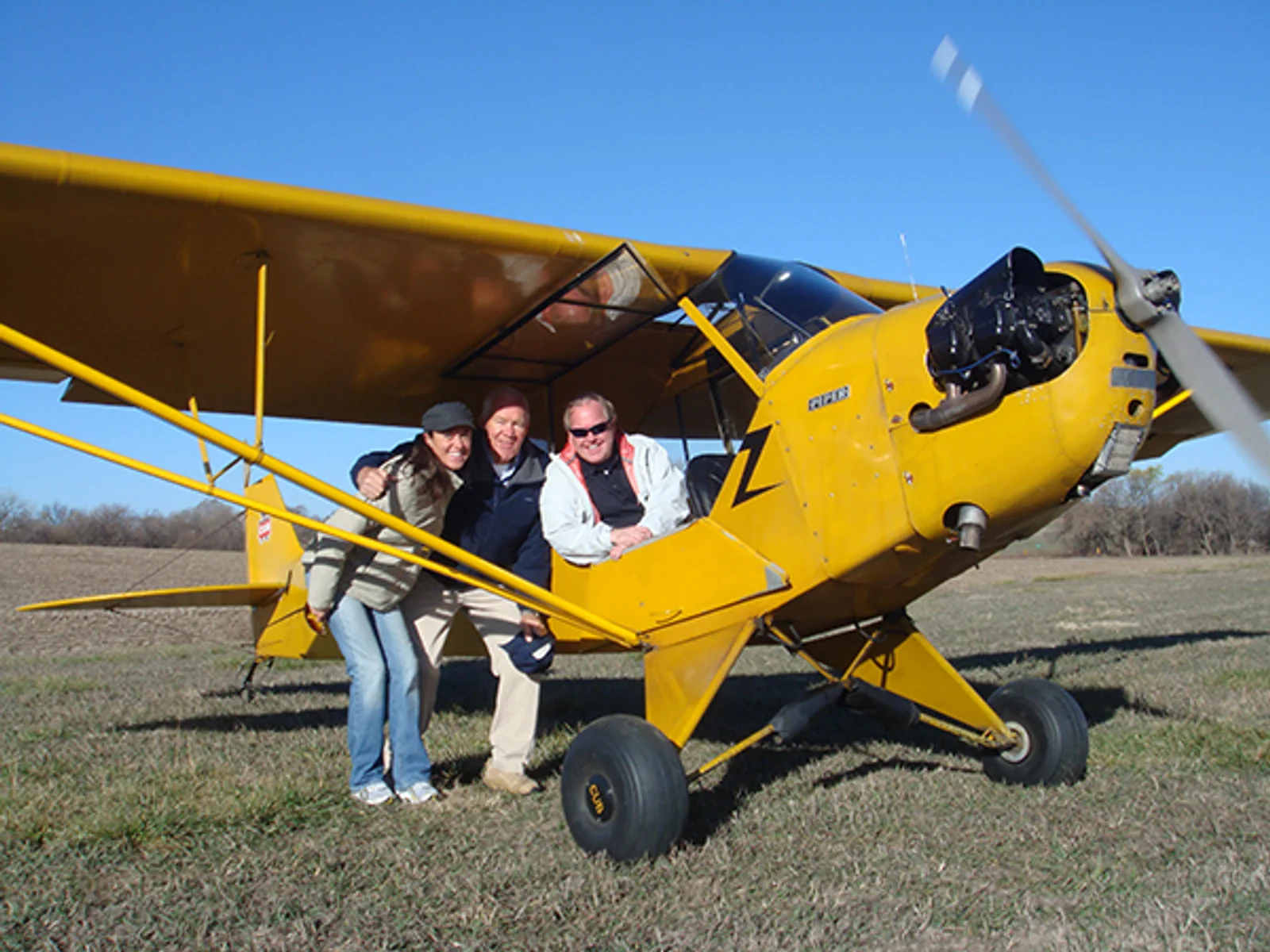 Todd Duncan, pictured with Harry Barr and Jessy Panzer, soloed in the same classic yellow 1941 Piper J-3 Cub his dad, Chairman Emeritus Robert Duncan, did years ago.