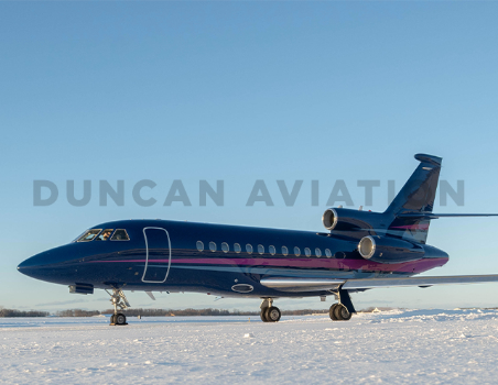 Newly painted Falcon 900 exterior in deep navy with magenta and light blue stripe