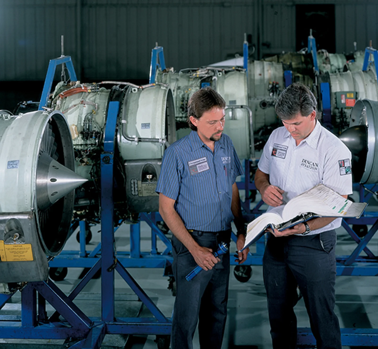 Mark Earnest and Lance Boatwright of the Engine Shop discuss repair and inspection procedures in 1998.
